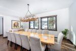 The dining room features oversized custom dining table with seating for 12 guests.